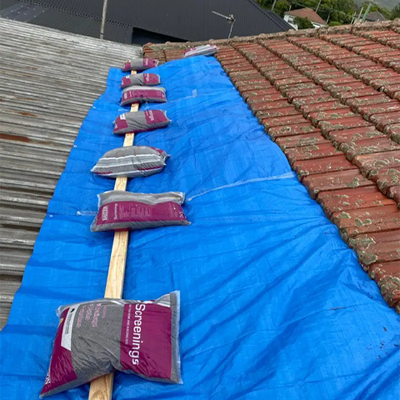 Tarp weighed down with sandbags on a roof